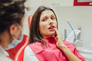 woman at dentist with gum pain