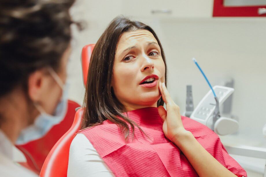 woman at dentist with gum pain
