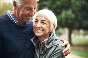 older man with arm around older woman